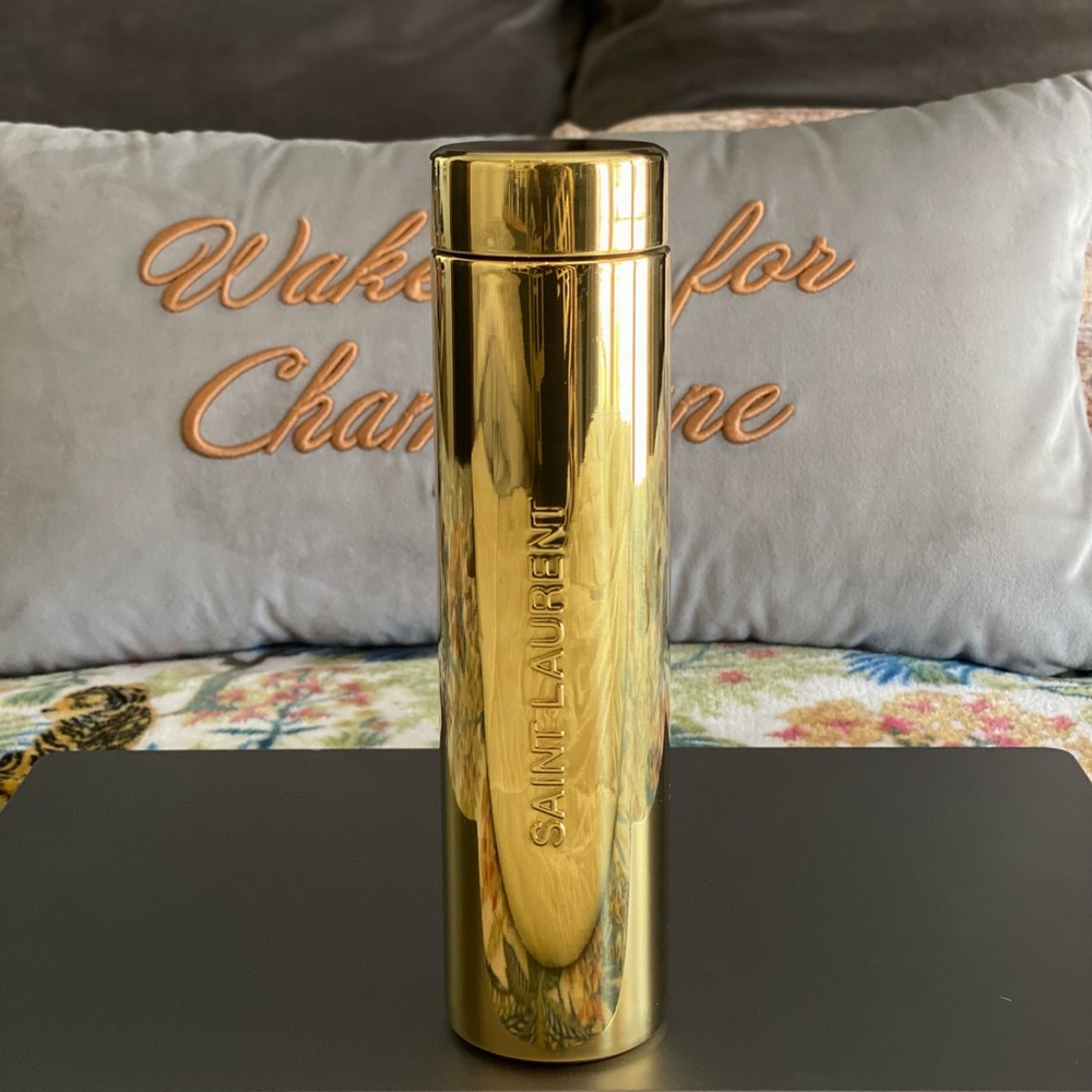 Saint Laurent gold metal travel water bottle.